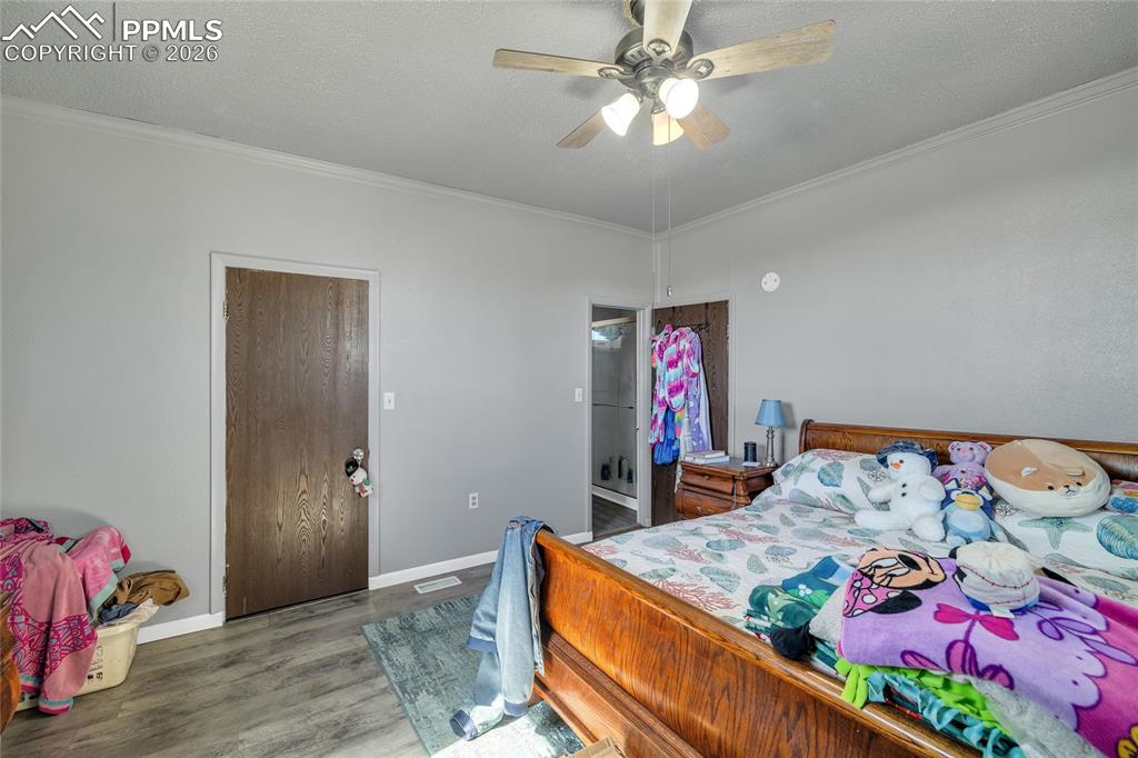 Image 18 of 49: Full bathroom with tile walls, a shower stall, and wainscoting