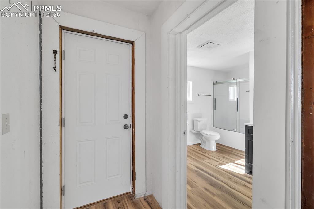 Image 31 of 49: Kitchen with stainless steel appliances, glass insert cabinets, white cabin