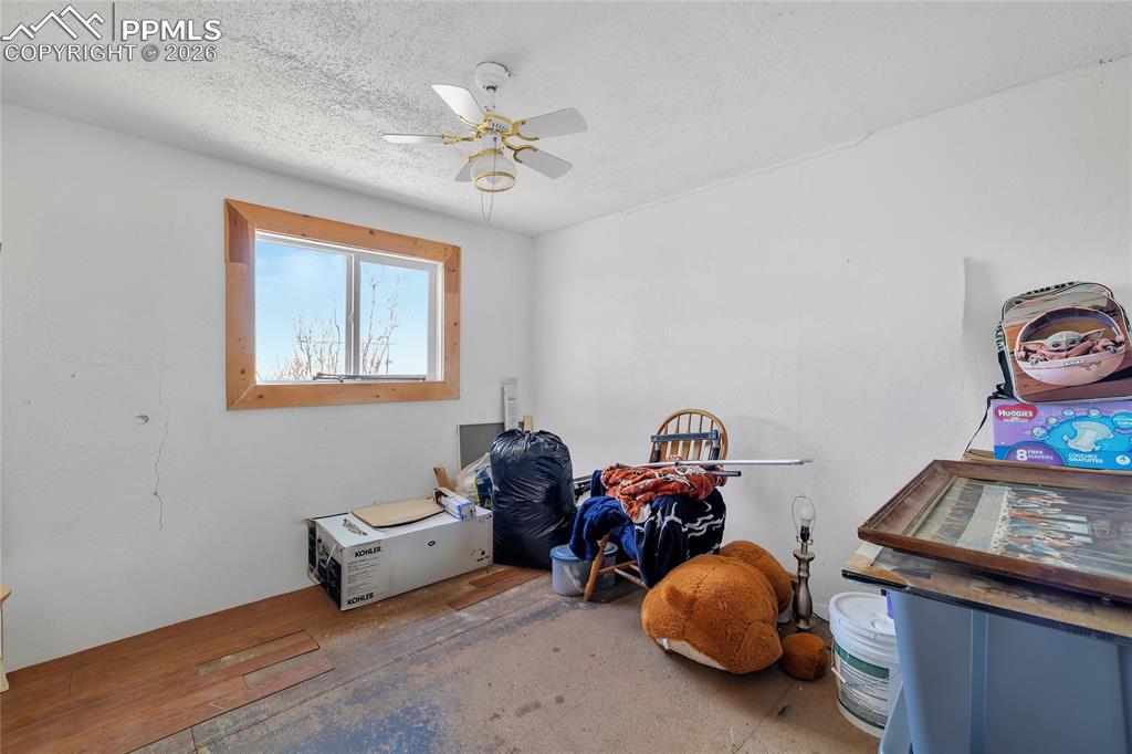 Image 33 of 49: ADU Unfurnished bedroom featuring light wood finished floors, a textured ce