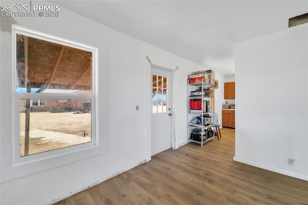Image 39 of 49: ADU Empty room with wood finished floors and ceiling fan
