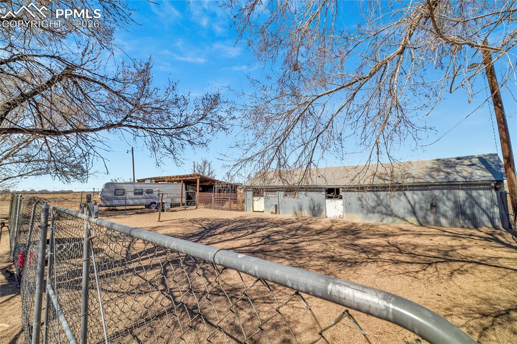 Image 43 of 49: ADU Unfurnished room with dark wood-style flooring and ceiling fan