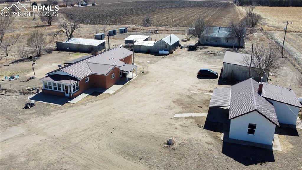 Image 5 of 49: View of front of property with a metal roof, covered porch, and stucco sidi