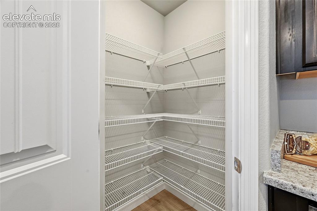 Image 12 of 30: Pantry with extensive wire shelving, offering multiple levels of storage
