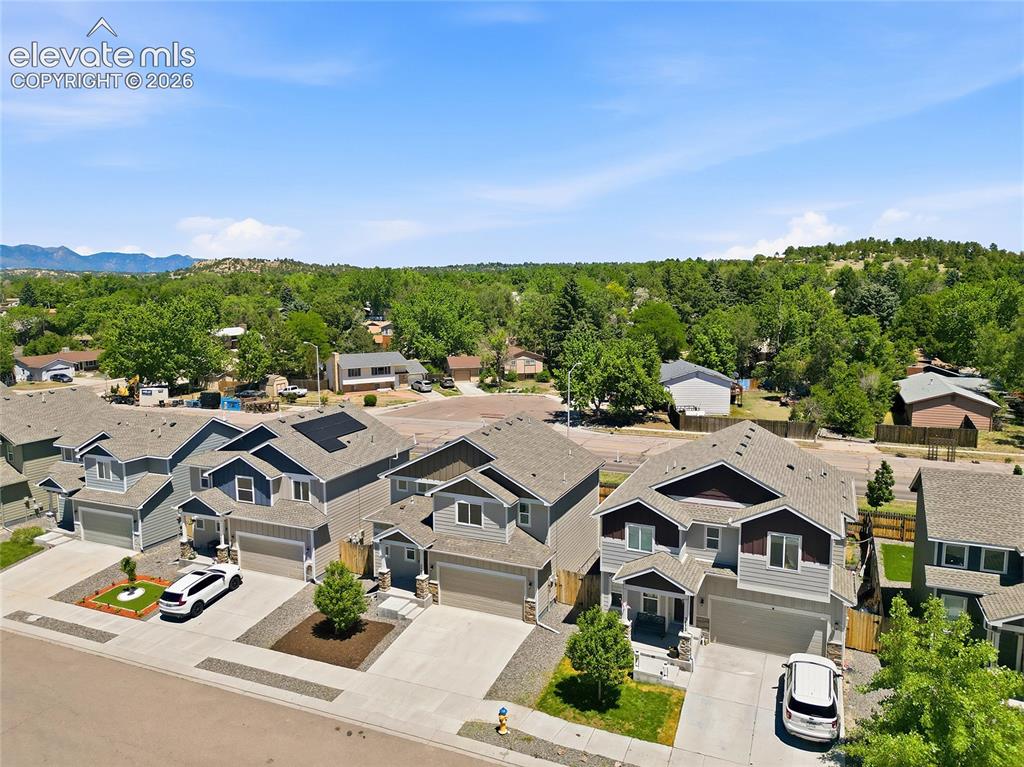 Image 26 of 30: Modern residential streetscape featuring two-story homes with attached gara