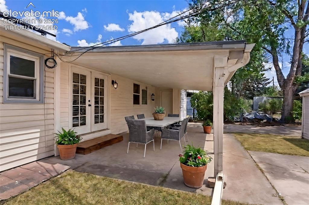 Image 16 of 21: Virtually Staged covered patio with plenty of room for gatherings of family