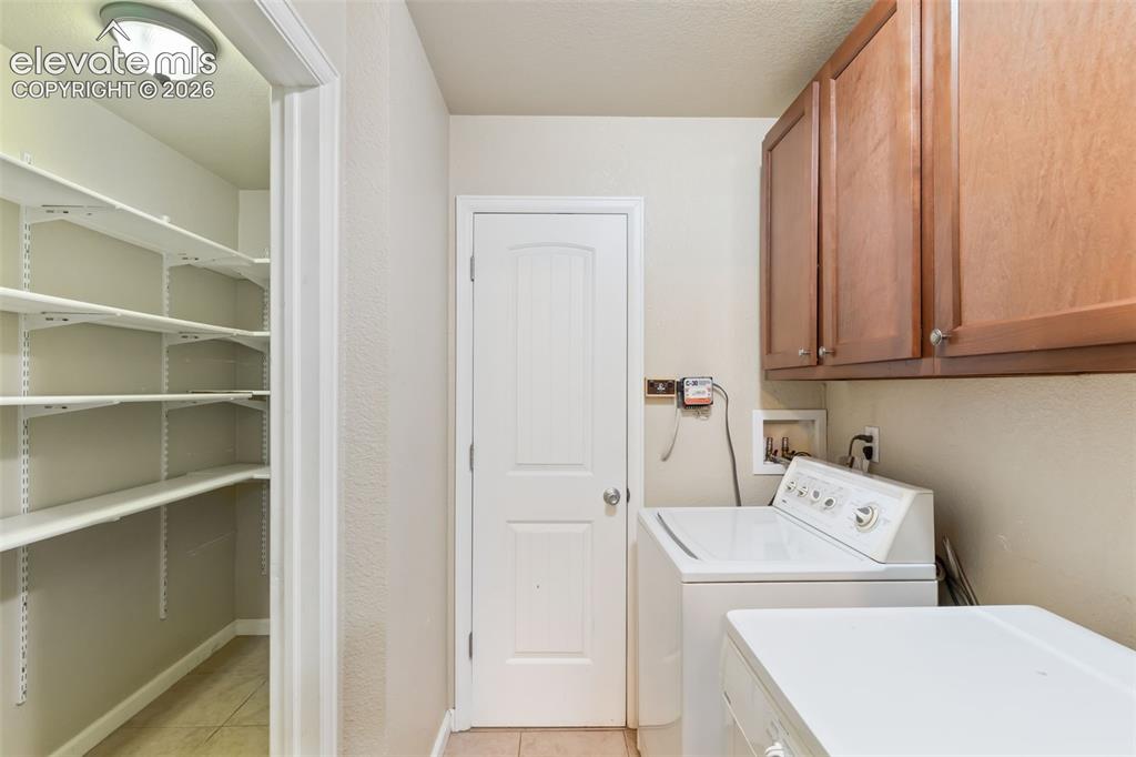 Image 18 of 21: Laundry & HUGE pantry! The door in the middle is the water heater closet
