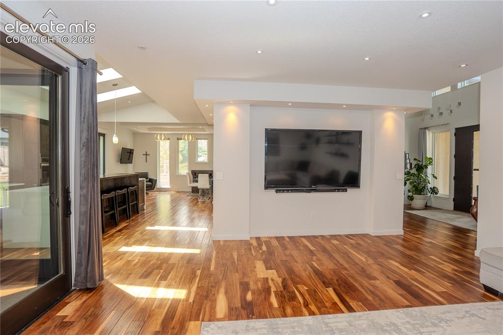 Image 21 of 50: From the living room, you can see the entrance and kitchen