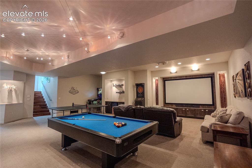 Image 37 of 50: Theater room, pool table, shuffle board, exercise room, 2 bedrooms, bath an