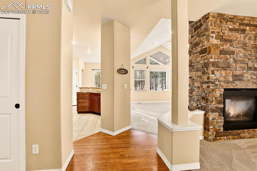 Image 11 of 45: View from Front Foyer featuring Dining room fireplace, new carpet throughou