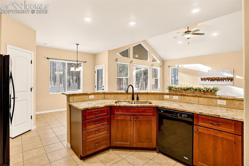 Image 18 of 45: Kitchen with open concept area open to Great Room, light tile patterned flo