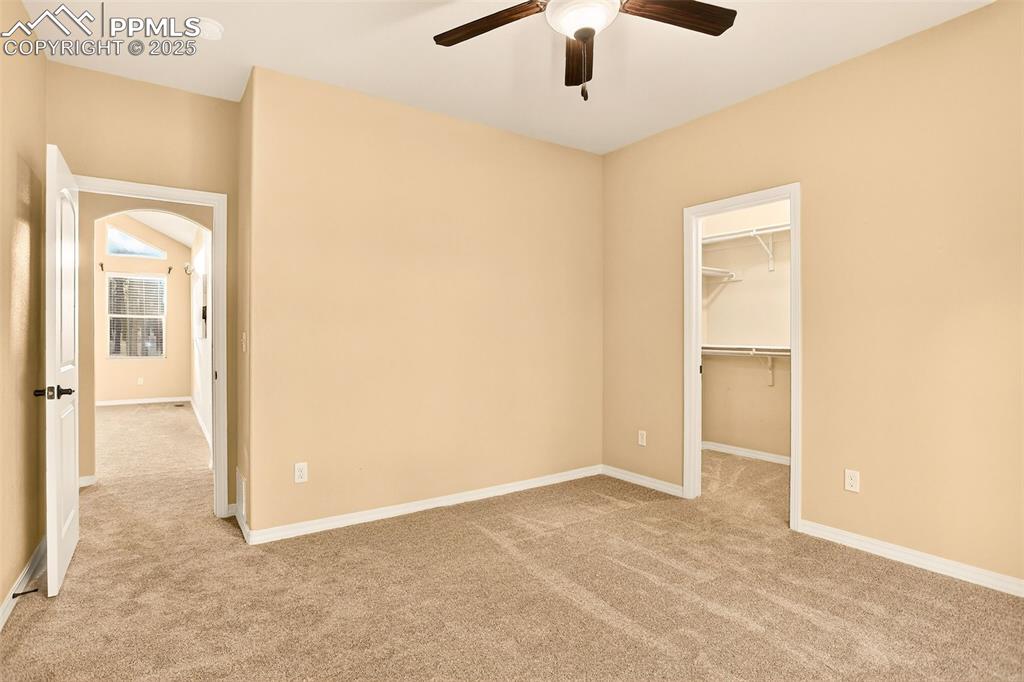 Image 26 of 45: Second bedroom featuring  walk in closet, new carpet, a spacious closet, a 