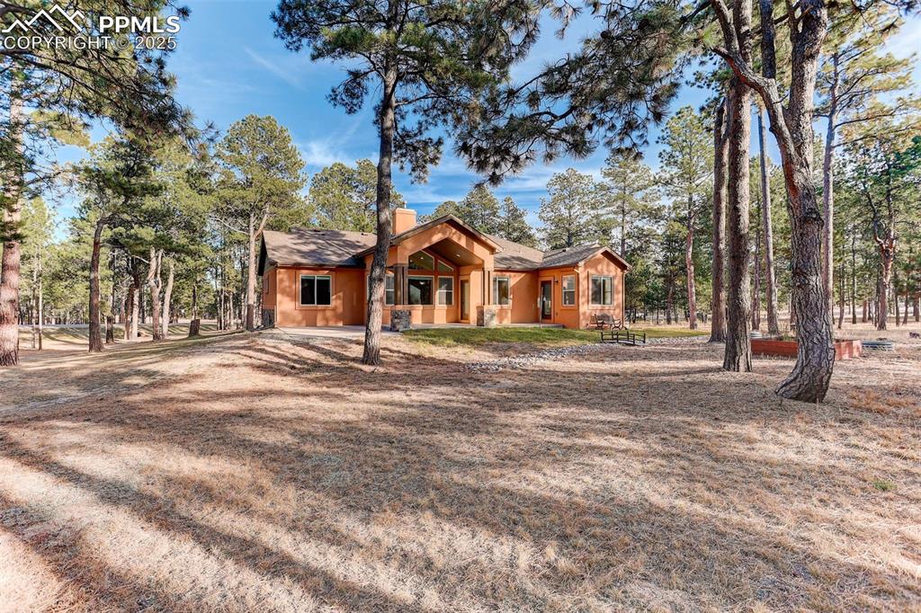 Image 31 of 45: View of back of house featuring a chimney