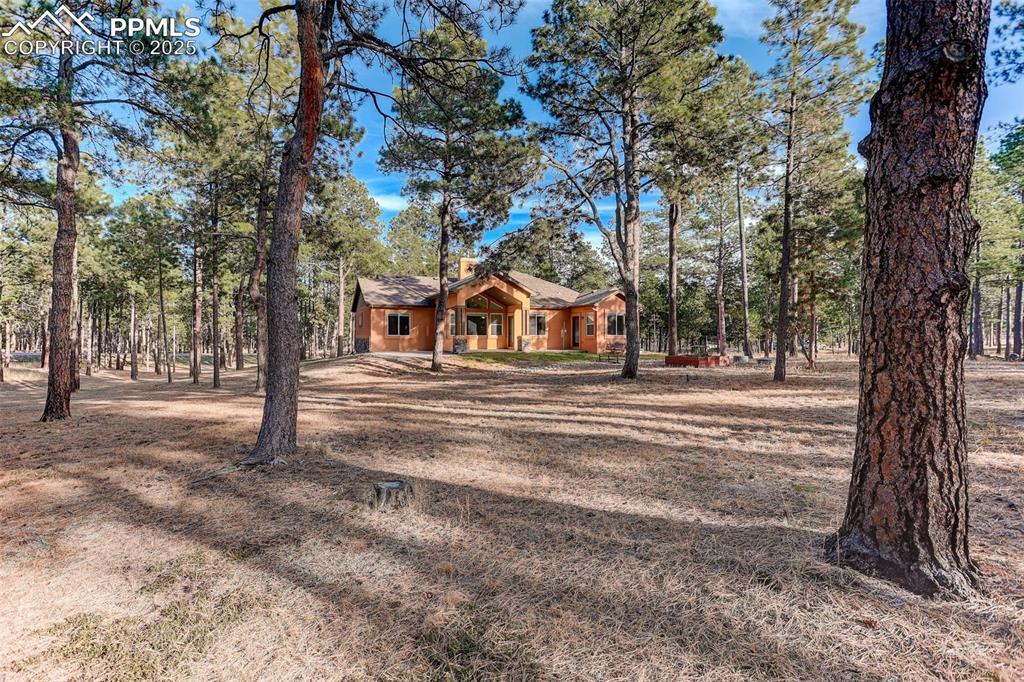 Image 32 of 45: View of back of house with roof with shingles