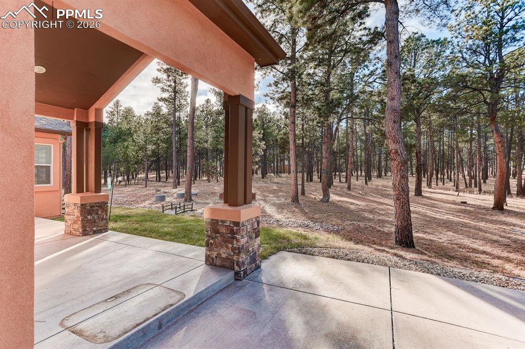 Image 33 of 45: View of rear covered patio looking into the backyard