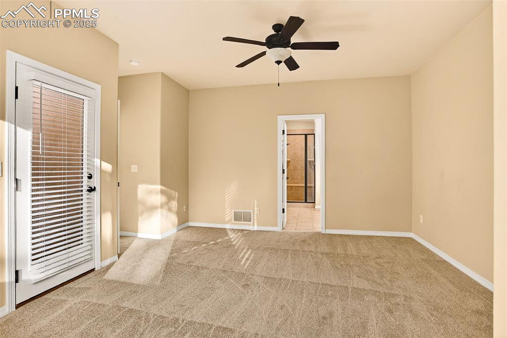 Image 38 of 45: Carpeted spare room featuring baseboards and ceiling fan