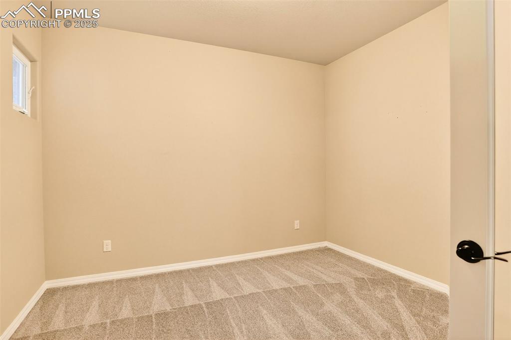 Image 39 of 45: Spare room with carpet floors and baseboards