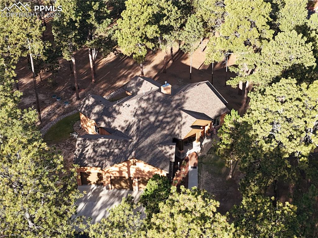 Image 9 of 45: View of property location with a tree filled landscape, taken from the side