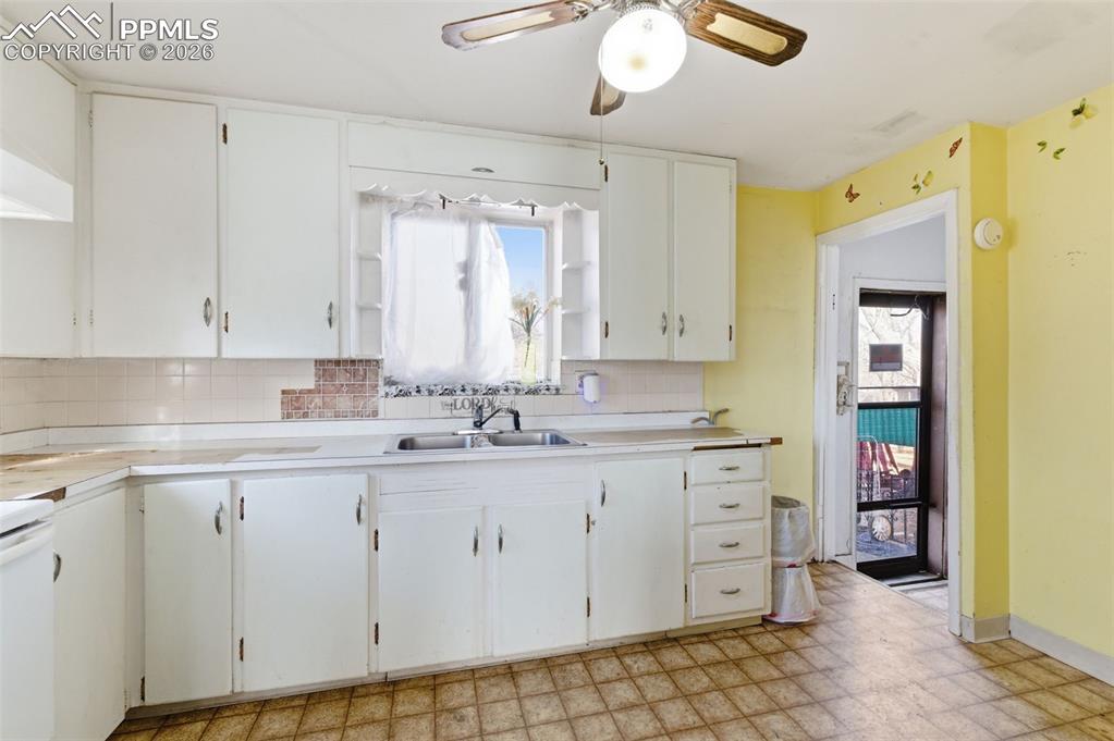 Image 12 of 35: Kitchen featuring light flooring, white cabinetry, light countertops, and a