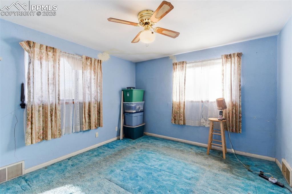 Image 14 of 35: Spare room with a ceiling fan and carpet