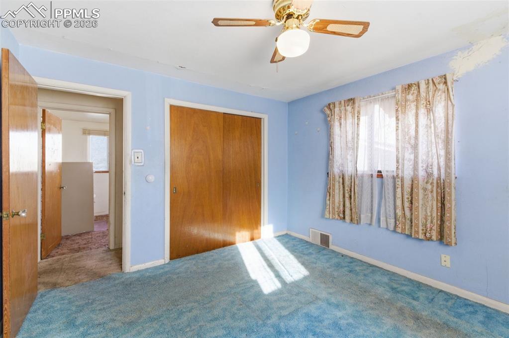 Image 15 of 35: Unfurnished bedroom featuring a closet, ceiling fan, and carpet floors