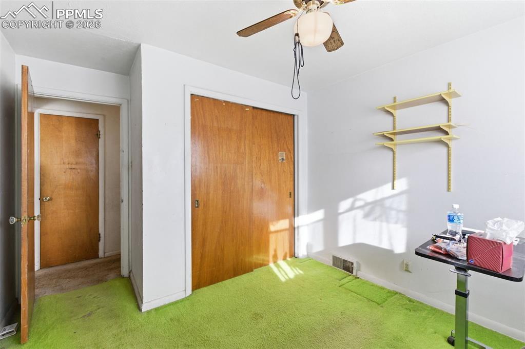 Image 19 of 35: Carpeted bedroom with a closet and ceiling fan