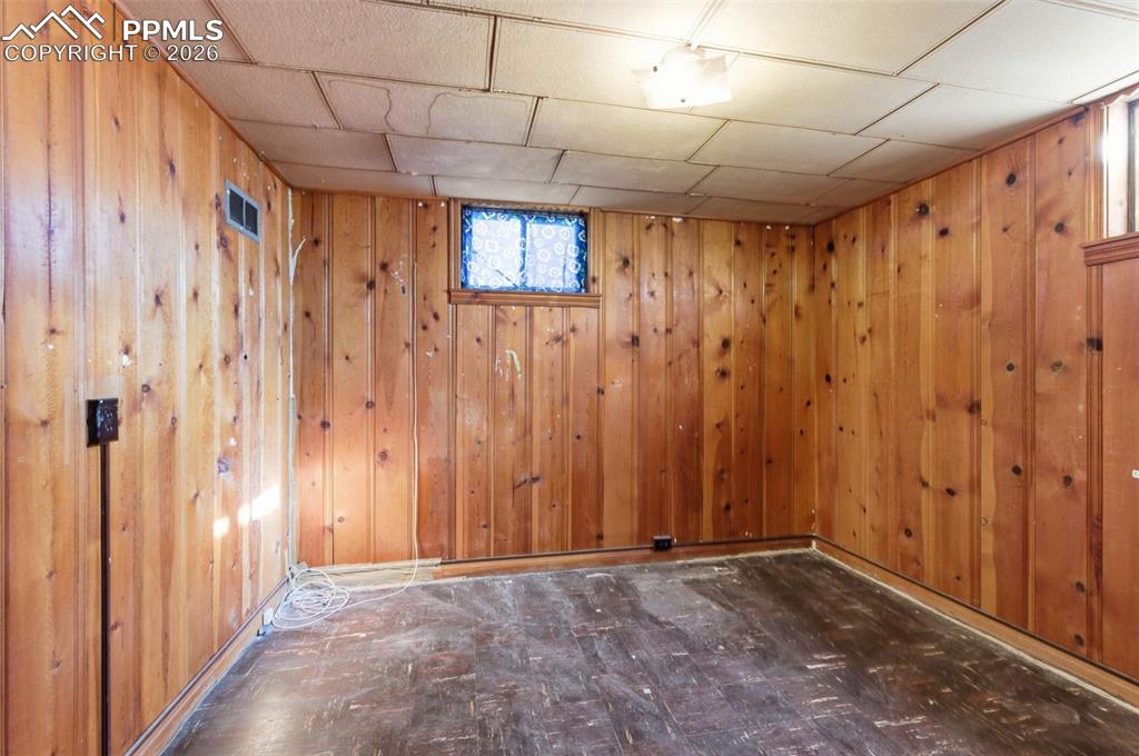 Image 27 of 35: Below grade area featuring dark flooring
