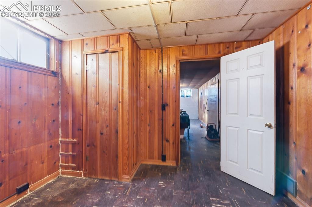 Image 28 of 35: Corridor featuring wood walls and baseboards