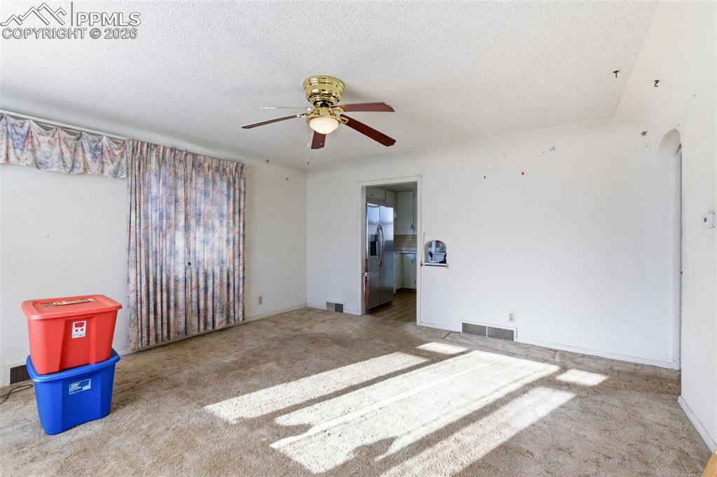 Image 5 of 35: Empty room with a textured ceiling and a ceiling fan