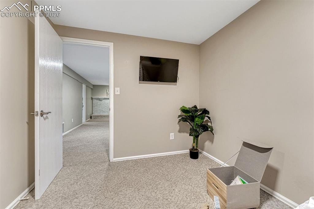Image 33 of 49: TV and wall mount included in 2 of 3 basement bedrooms