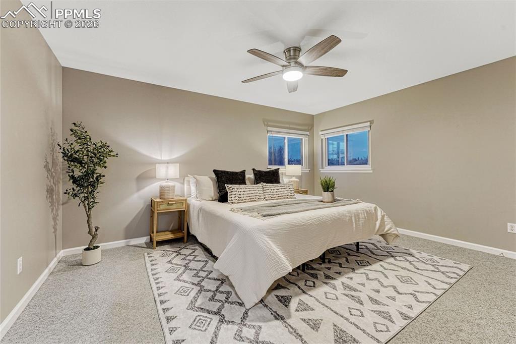 Image 5 of 49: Primary bedroom spacious enough for a king bed