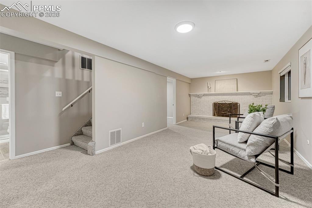 Image 8 of 49: Expansive family room with wood burniing fireplace
