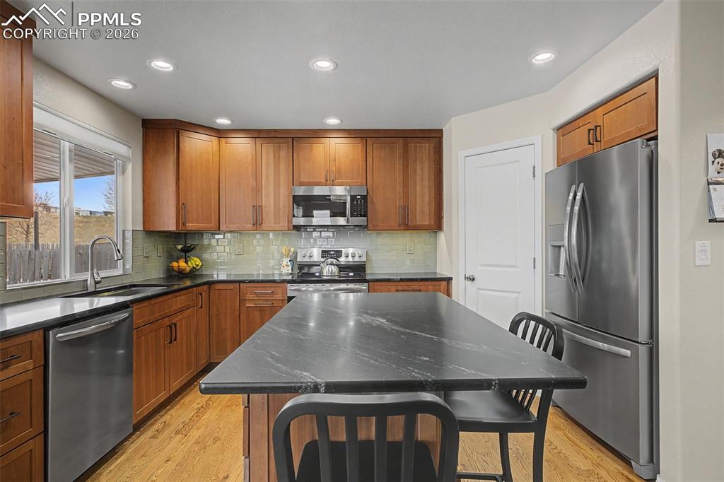 Image 13 of 50: Custom remodeled kitchen featuring a corner pantry and large island!