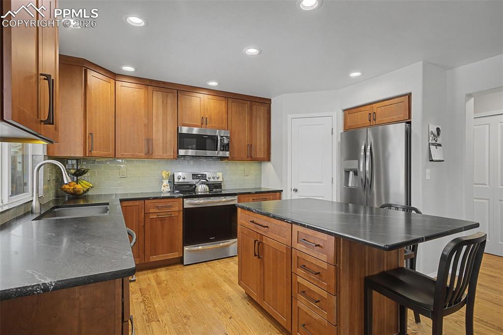 Image 15 of 50: Custom remodeled kitchen featuring a corner pantry and large island!