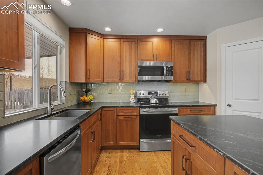Image 16 of 50: Custom remodeled kitchen featuring a corner pantry and large island!