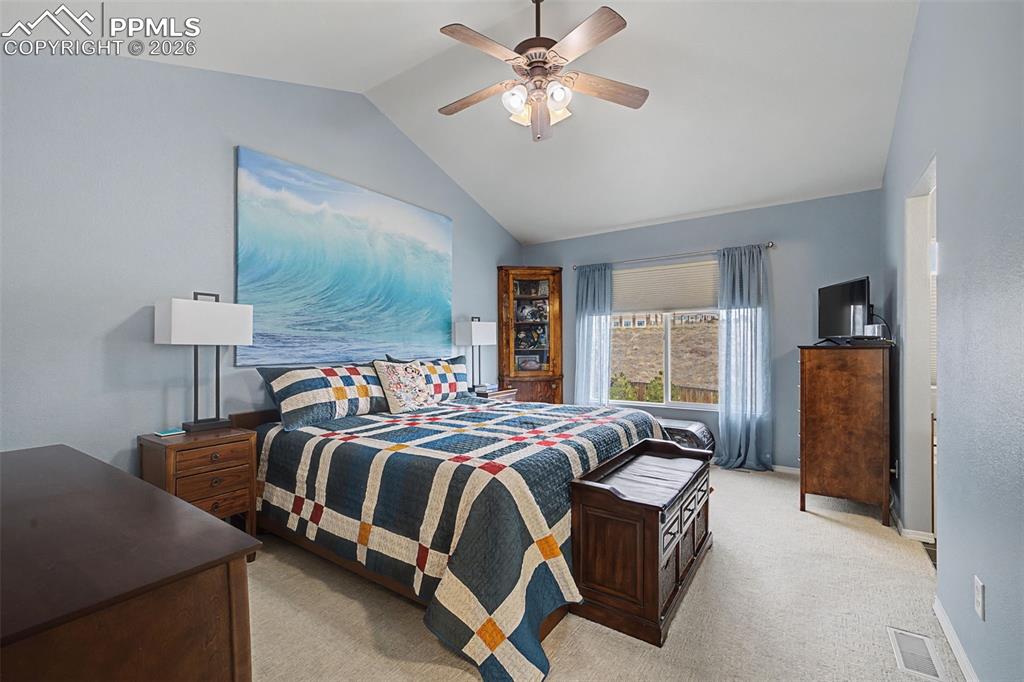 Image 20 of 50: Primary bedroom with vaulted ceilings and attached bath and walk in closet!