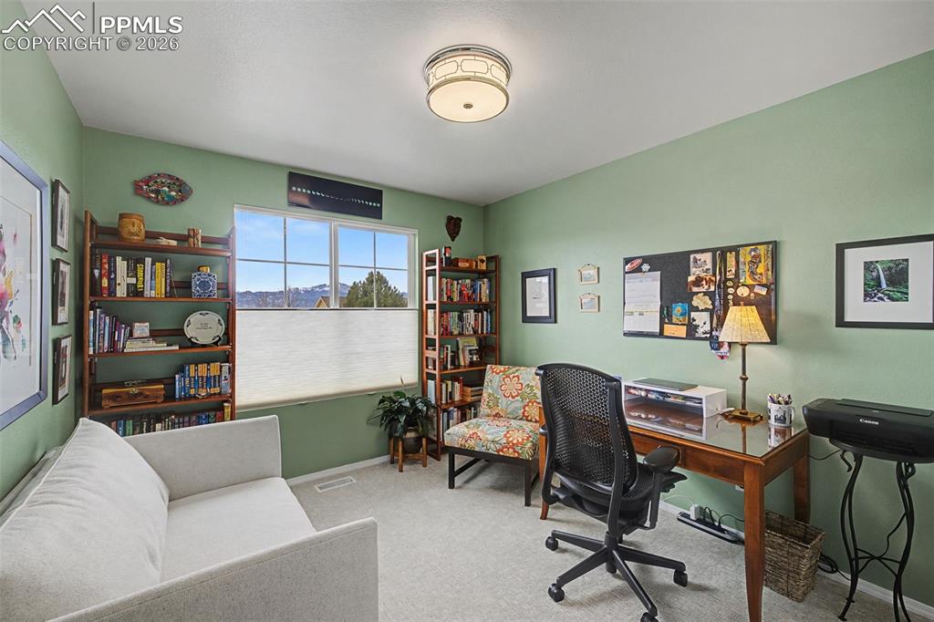 Image 25 of 50: Upstairs secondary bedroom being used as an office.