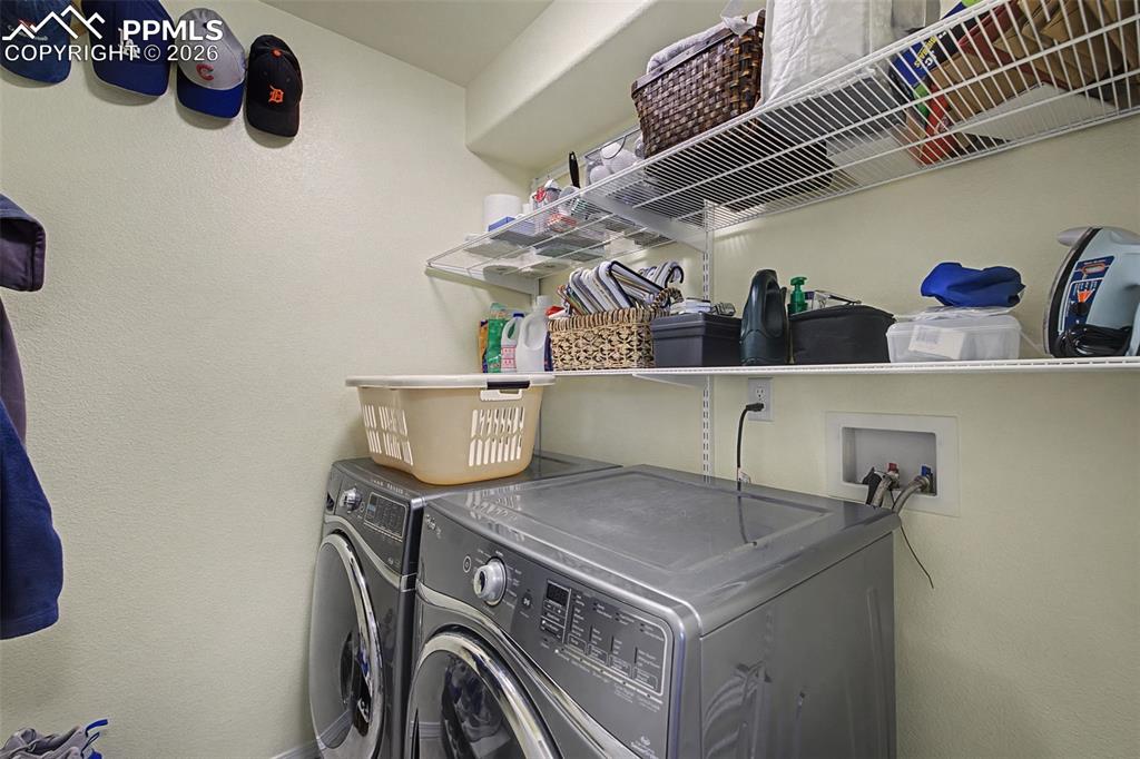 Image 40 of 50: Main level laundry room off of the entrance from the garage.