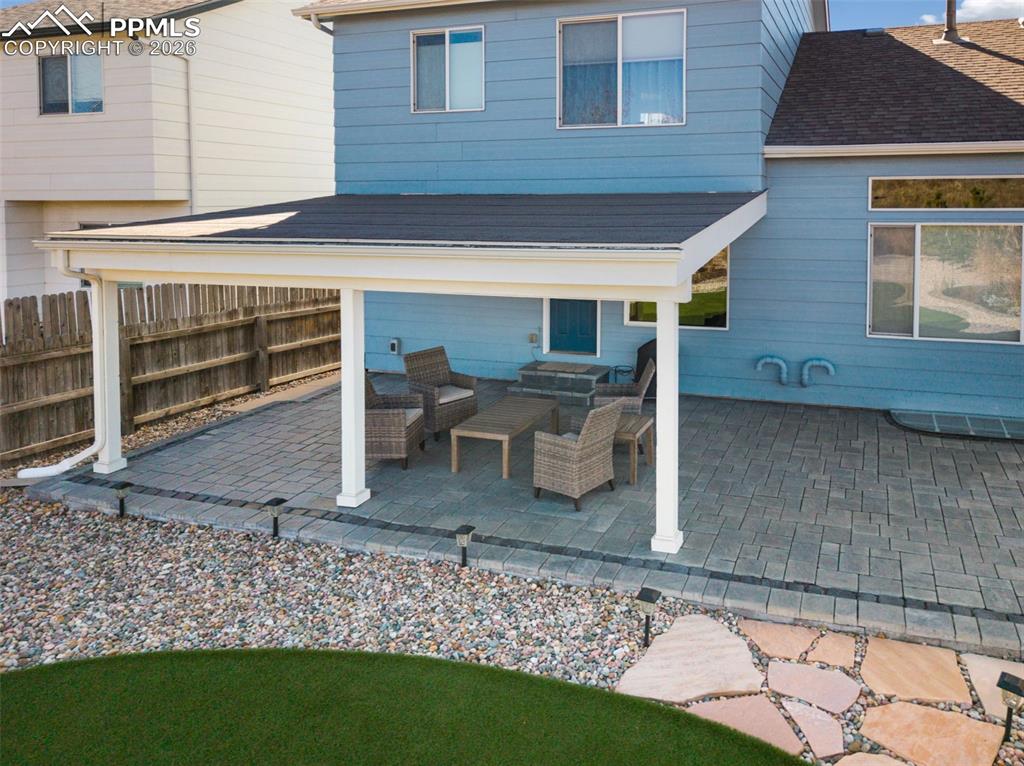 Image 43 of 50: Large stamped covered patio for entertaining!