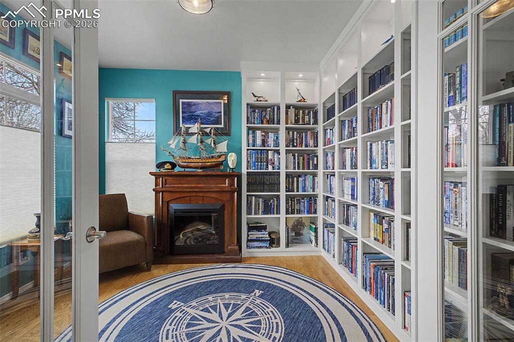 Image 5 of 50: Main level dedicated office with built-ins and a fireplace that stays!