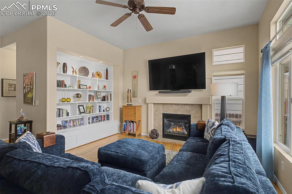 Image 6 of 50: Welcoming main level family room with more built ins and fireplace!