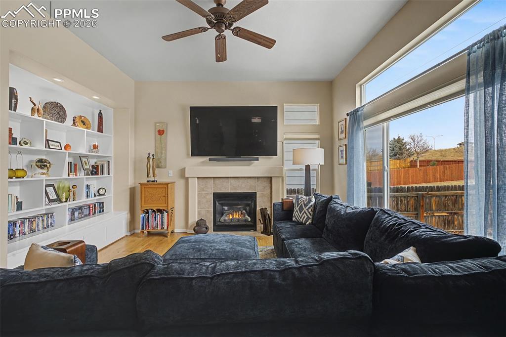 Image 7 of 50: Welcoming main level family room with more built ins and fireplace!