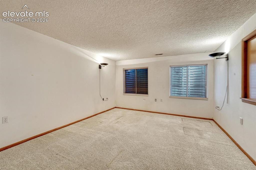 Image 10 of 50: A versatile basement family room for movie nights, game time, play room, or