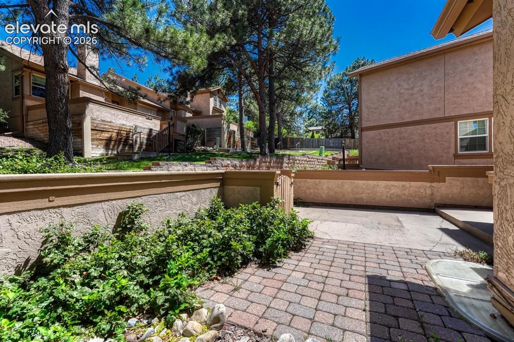 Image 17 of 48: Paver patio in the front courtyard.