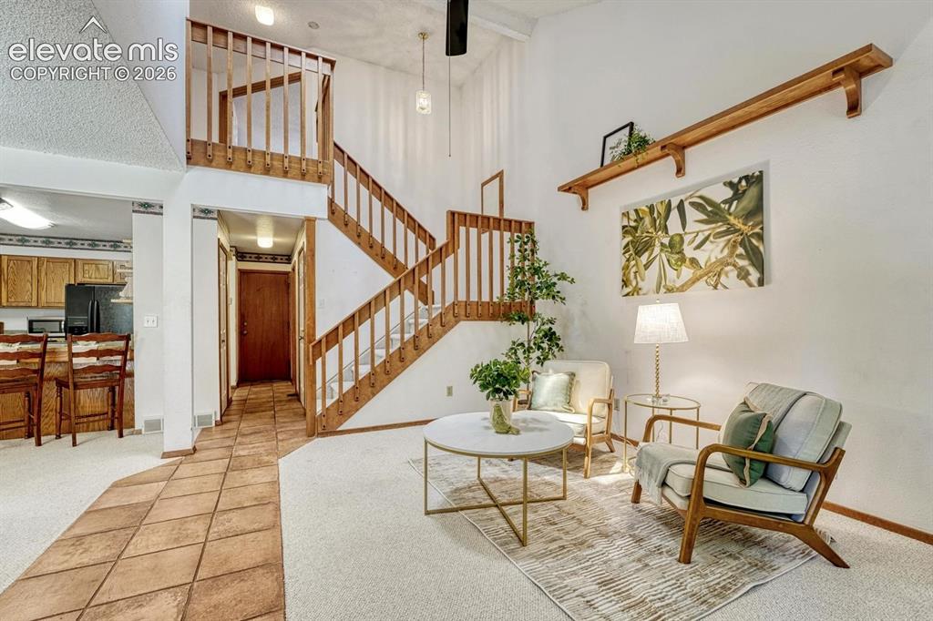 Image 19 of 48: View of the entry, living room, and stairs to the upper level.