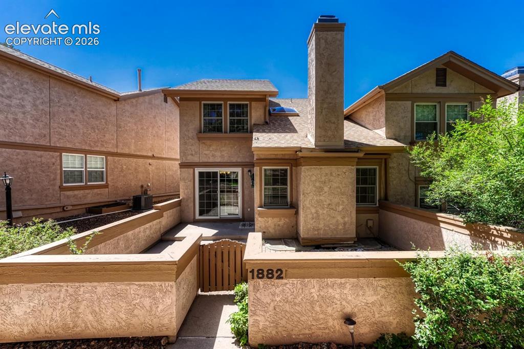 Image 2 of 48: Enclosed courtyard with a concrete and paver patio for outdoor relaxation a