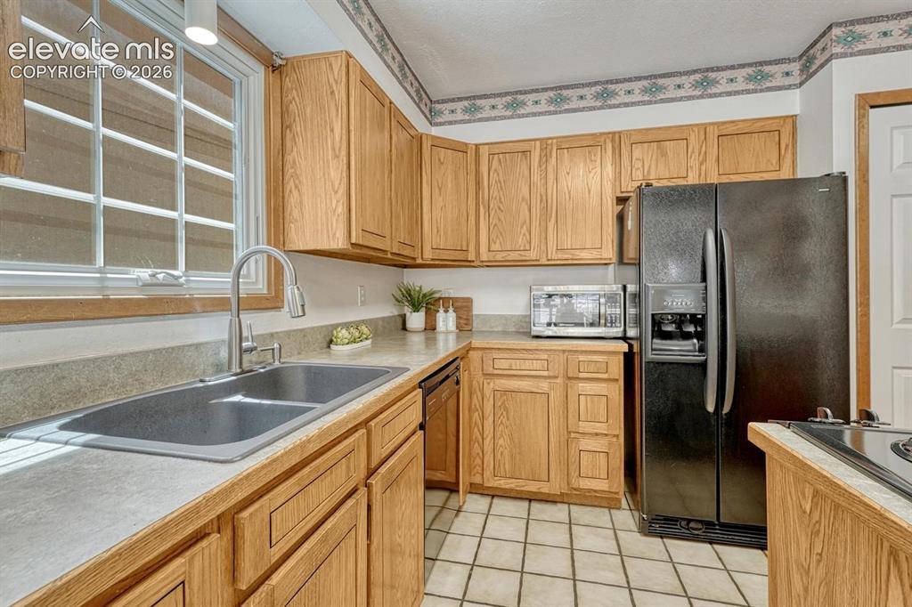 Image 22 of 48: Inviting kitchen with two pantries, beautiful wood cabinetry and lots of co