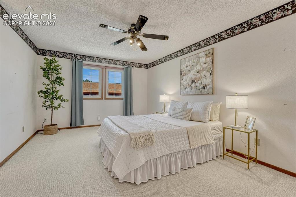Image 31 of 48: The spacious upper level primary bedroom is a private retreat that features