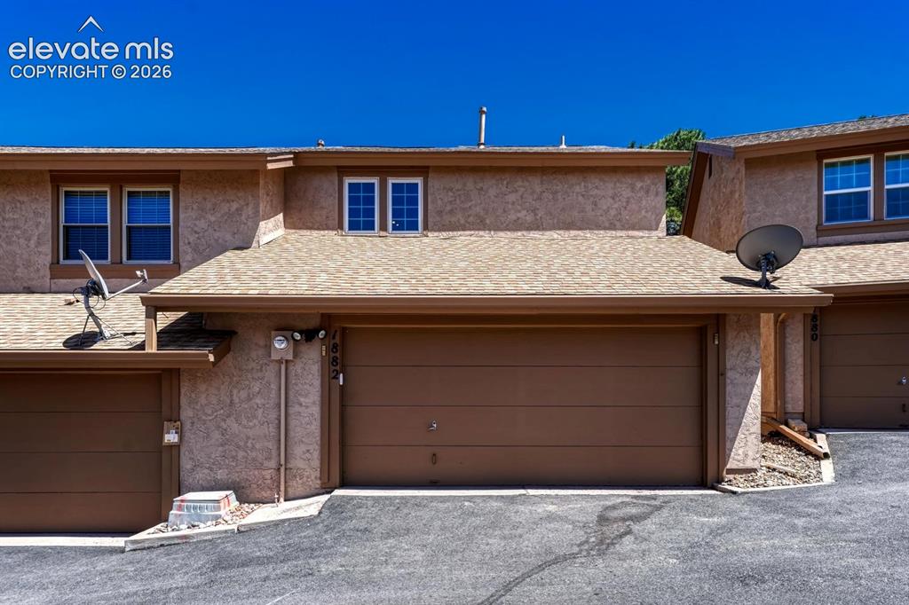 Image 42 of 48: Over-sized 2-car garage with storage and a work area.