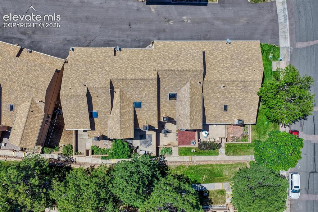 Image 44 of 48: Aerial view of complex and tree-line walkway.