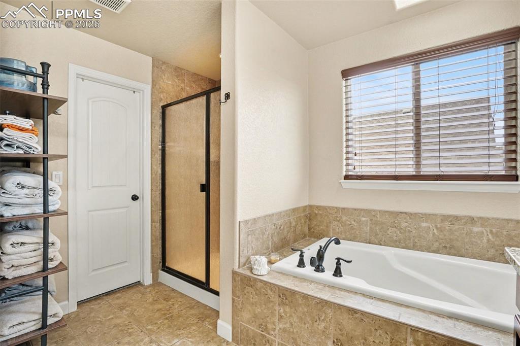 Image 15 of 31: Separate tub and shower in 5-piece master bathroom